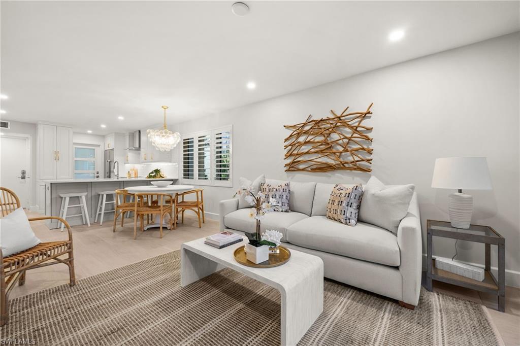 1300 Gulf Shore Boulevard North, Unit 109 Naples, FL 34102 - Photo 3 of 42 Bright and inviting open-concept living with stylish board and batten accents and coastal-inspired design.