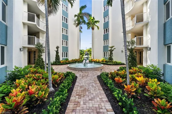 a view of a multi story building with a yard