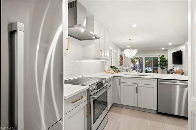 a kitchen with cabinets and stainless steel appliances