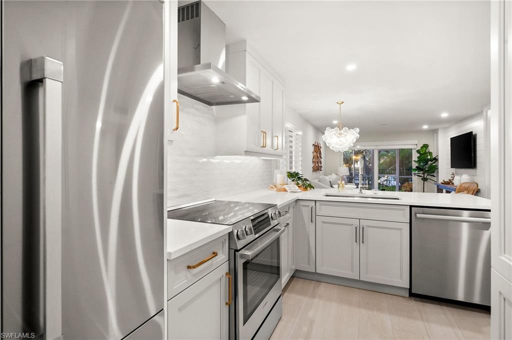 1300 Gulf Shore Boulevard North, Unit 109 Naples, FL 34102 - Photo 7 of 42 Chef-inspired kitchen featuring premium Fisher & Paykel and Bosch appliances