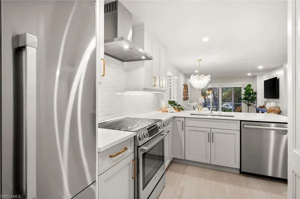 a kitchen with cabinets and stainless steel appliances