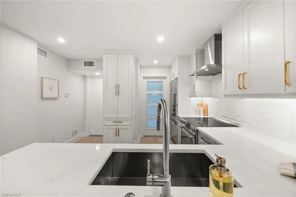 a kitchen with a sink and a refrigerator