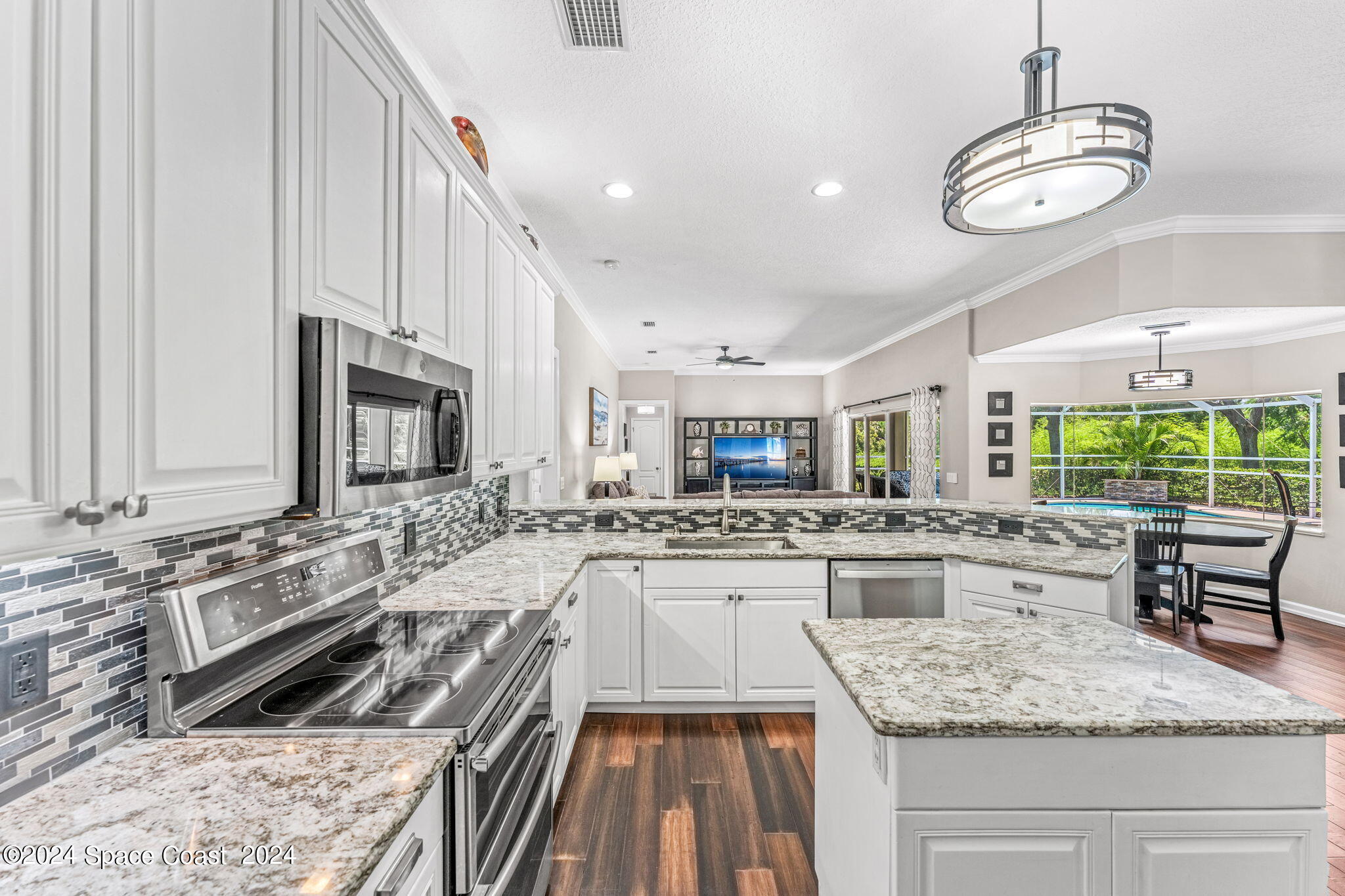 1633 Quinn Drive Rockledge, FL 32955 - Photo 15 of 50 a kitchen with stainless steel appliances granite countertop a sink stove and refrigerator