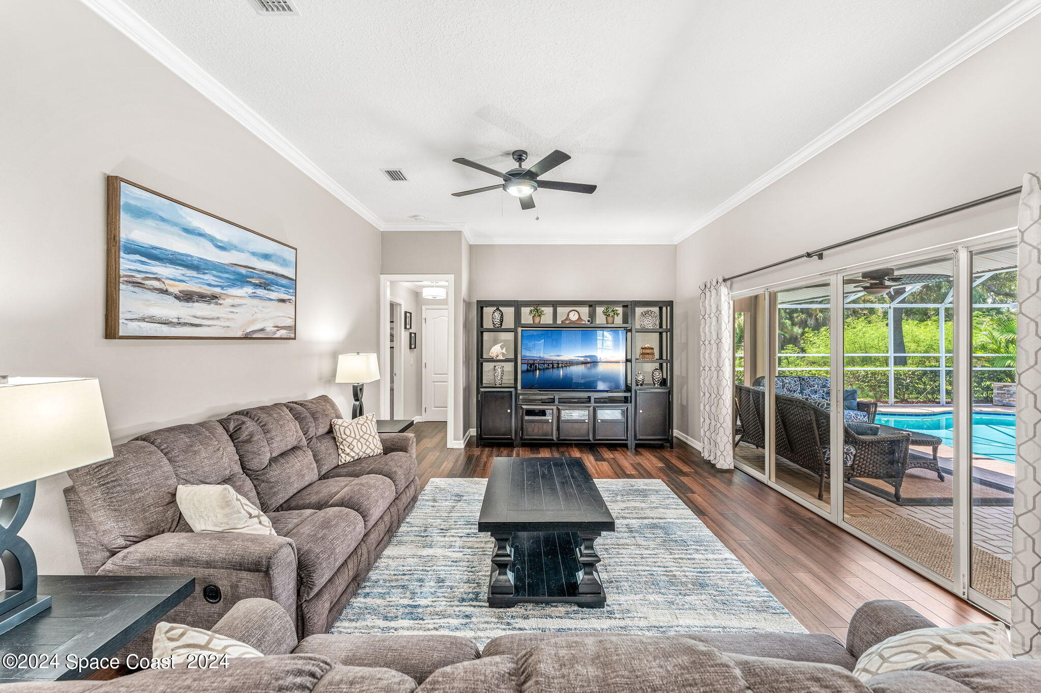 1633 Quinn Drive Rockledge, FL 32955 - Photo 17 of 50 a living room with furniture flat screen tv and a large window