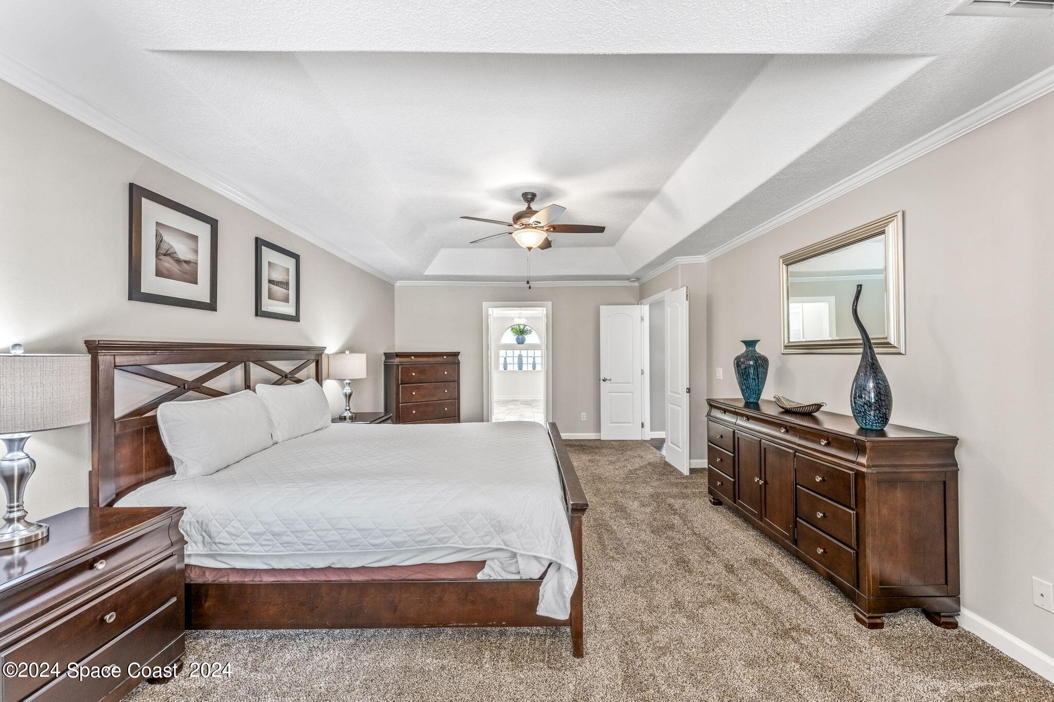 1633 Quinn Drive Rockledge, FL 32955 - Photo 20 of 50 a spacious bedroom with a bed and dresser with mirror