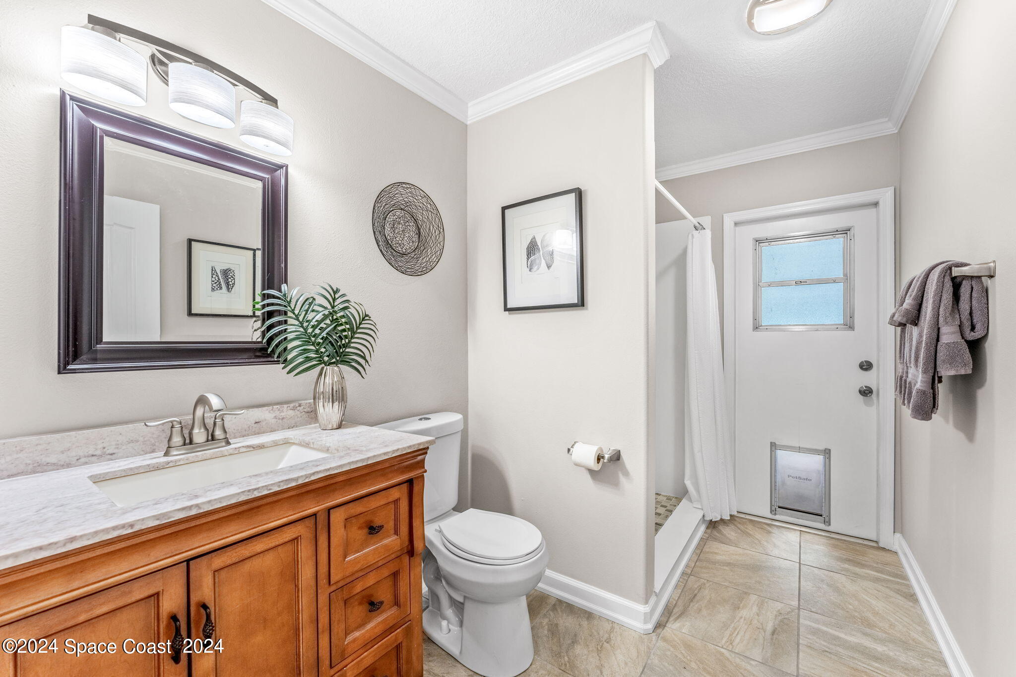 1633 Quinn Drive Rockledge, FL 32955 - Photo 26 of 50 a bathroom with a granite countertop toilet sink and mirror