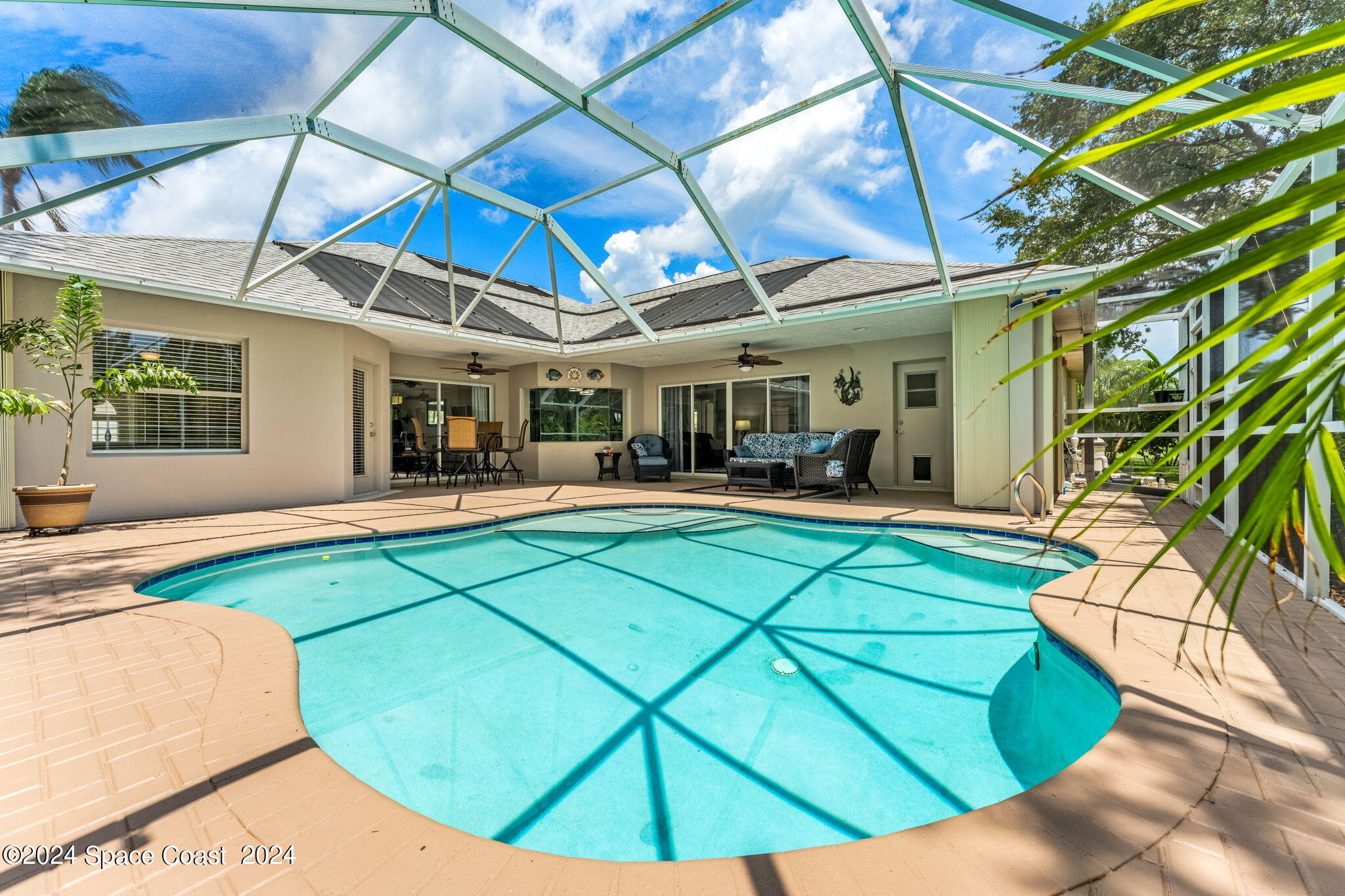 1633 Quinn Drive Rockledge, FL 32955 - Photo 34 of 50 a view of a swimming pool with a patio and a yard