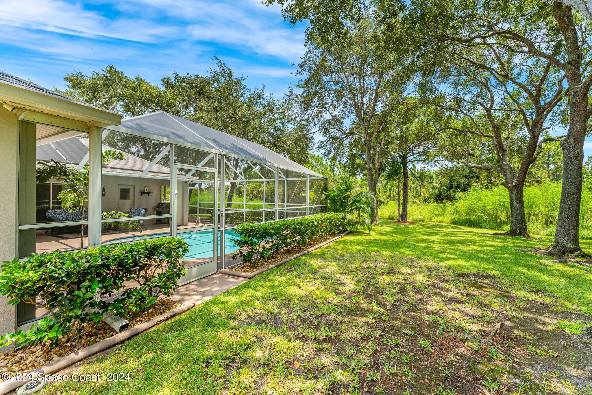 1633 Quinn Drive Rockledge, FL 32955 - Photo 38 of 50 a view of a house with a big yard and large trees