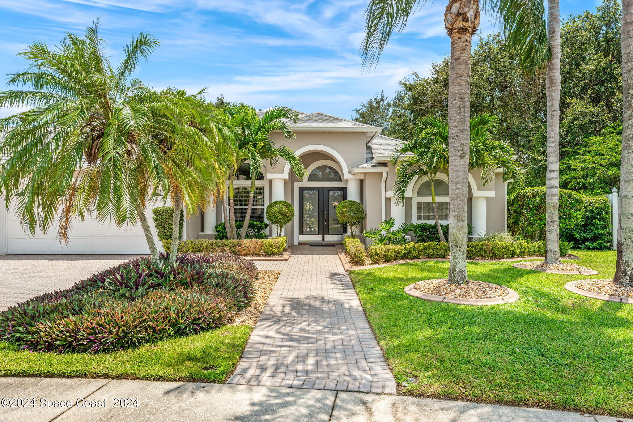 1633 Quinn Drive Rockledge, FL 32955 - Photo 48 of 50 a front view of a house with a garden and trees