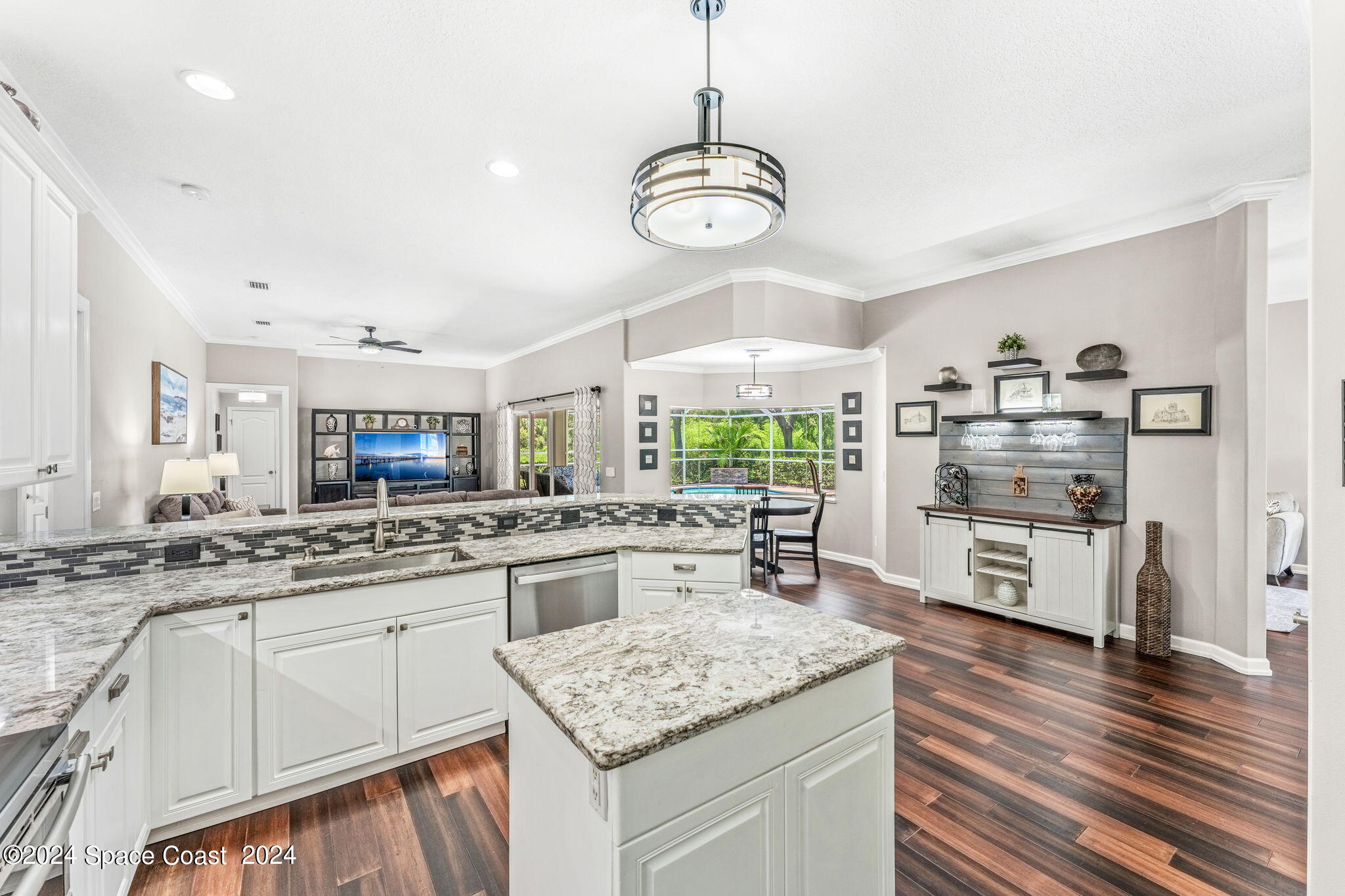 1633 Quinn Drive Rockledge, FL 32955 - Photo 10 of 50 a kitchen with stainless steel appliances granite countertop a lot of counter space and wooden floors