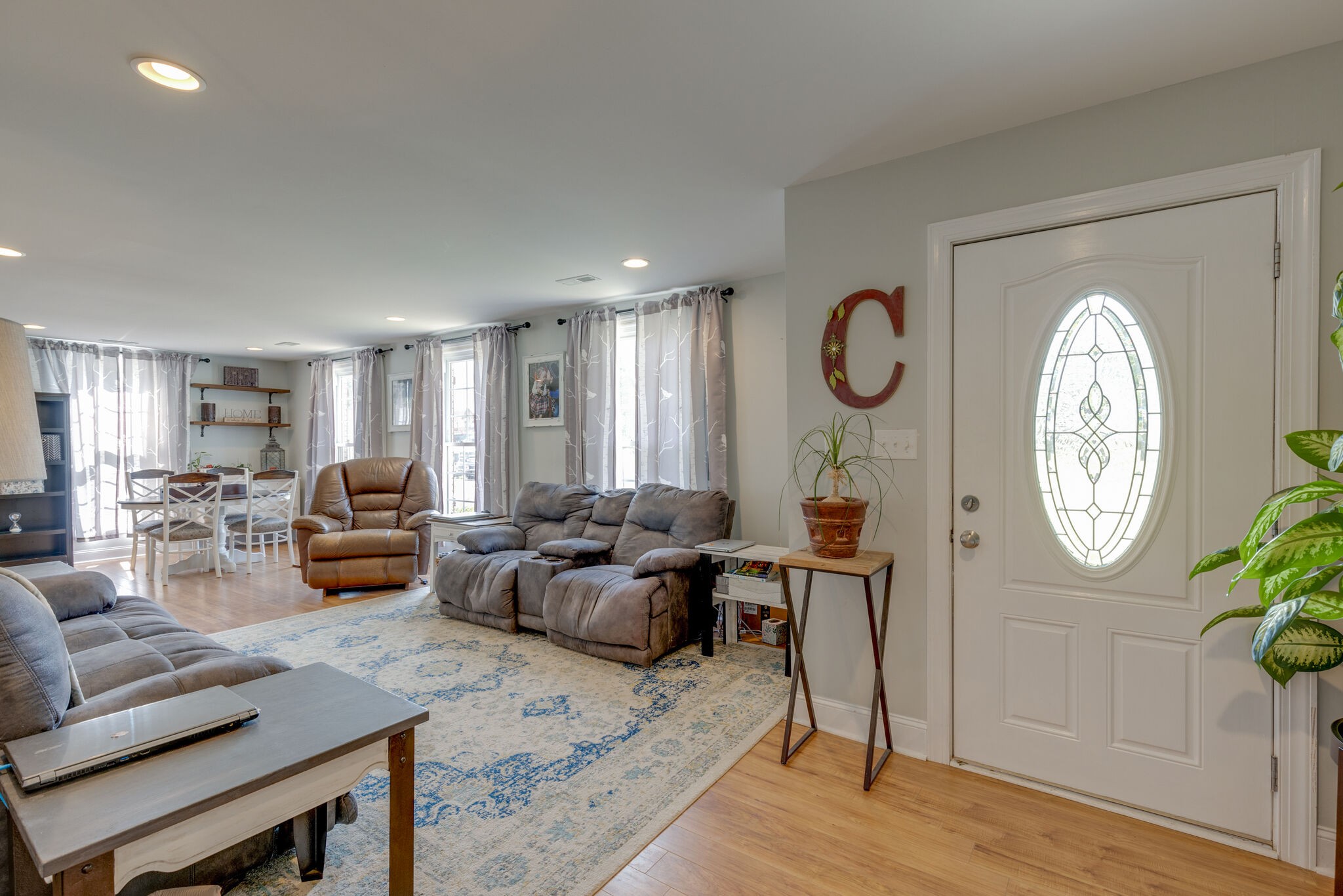 3003 Greens Mill Road Spring Hill, TN 37174 - Photo 2 of 48 a living room with furniture a clock on wall and a window