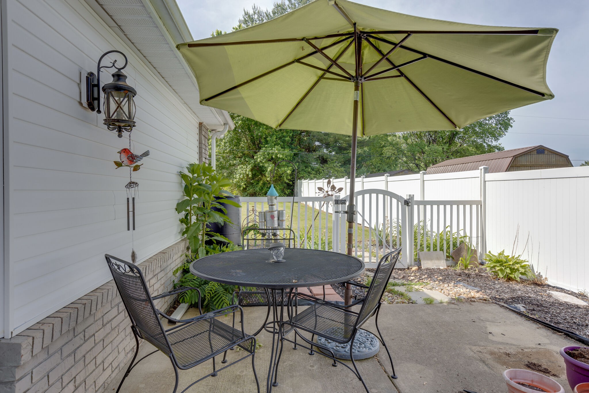 3003 Greens Mill Road Spring Hill, TN 37174 - Photo 28 of 48 a view of a patio with table and chairs under an umbrella