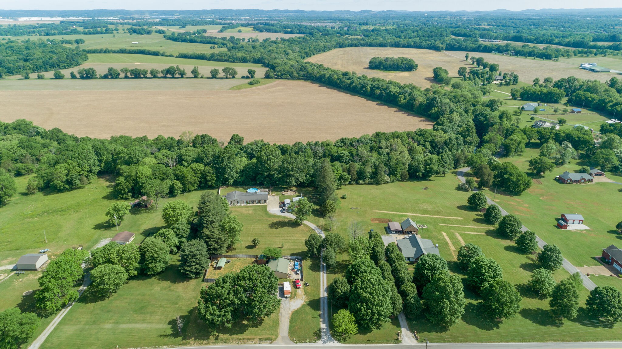 3003 Greens Mill Road Spring Hill, TN 37174 - Photo 39 of 48 an aerial view of green landscape with trees houses and lake view