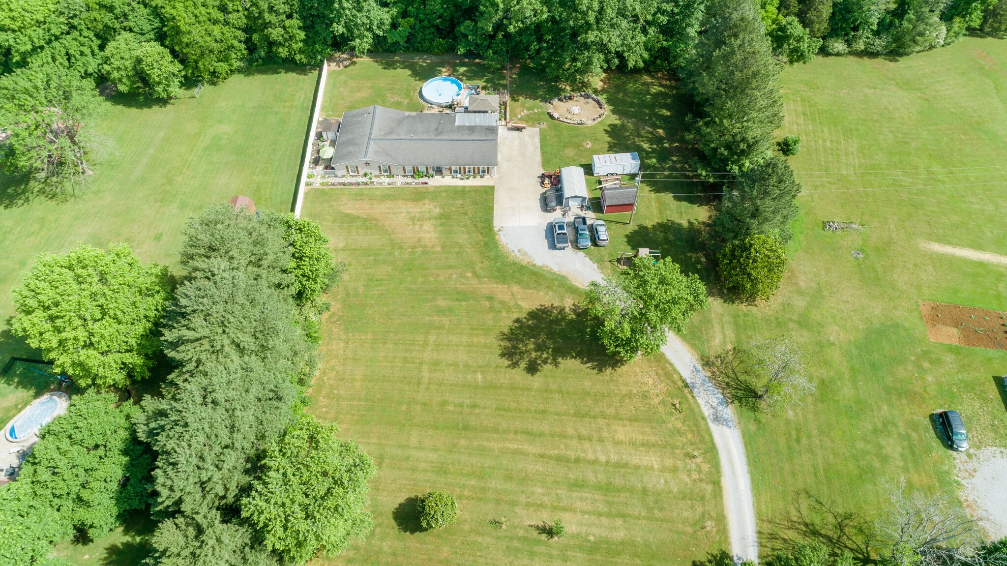 3003 Greens Mill Road Spring Hill, TN 37174 - Photo 44 of 48 a view of a yard with plants and large trees