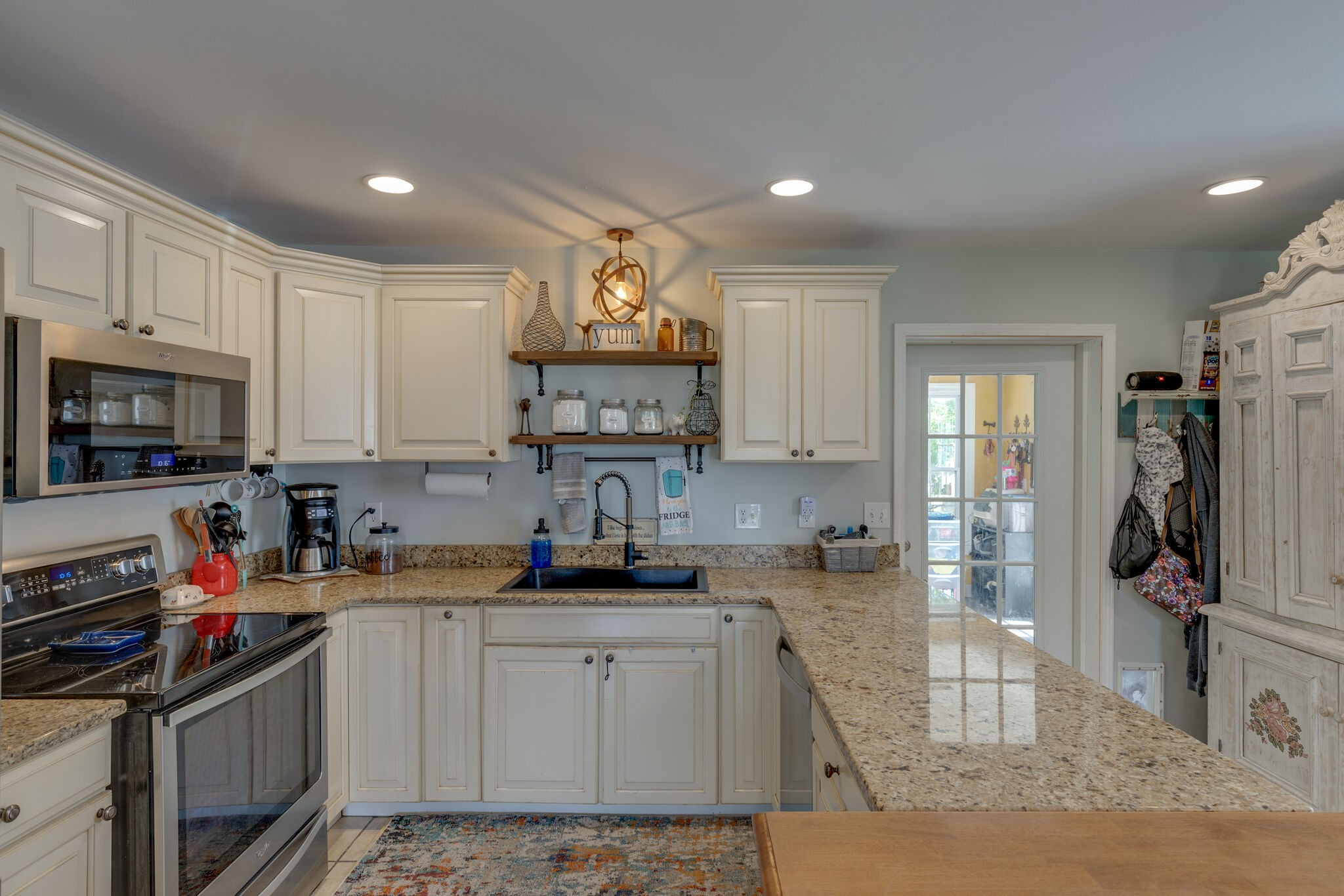 3003 Greens Mill Road Spring Hill, TN 37174 - Photo 8 of 48 a kitchen with kitchen island granite countertop a sink cabinets and stainless steel appliances