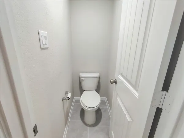 a white toilet sitting next to a small sink