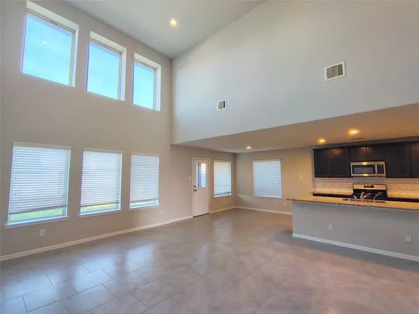a view of a livingroom with furniture and a window