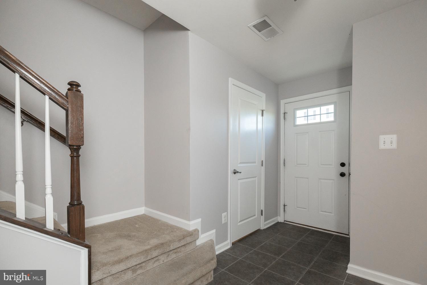 212 Fiesta Drive Stephenson, VA 22656 - Photo 3 of 37 Foyer with tile floors and powder room