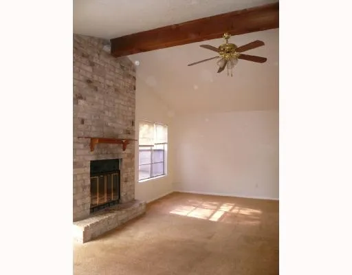 a view of empty room with a fireplace