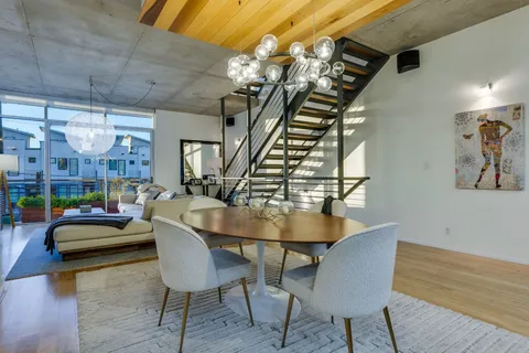 a dining room with furniture and wooden floor