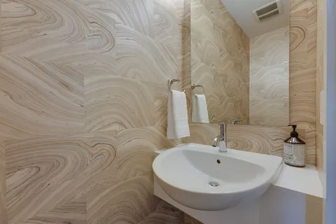 a bathroom with a sink and mirror