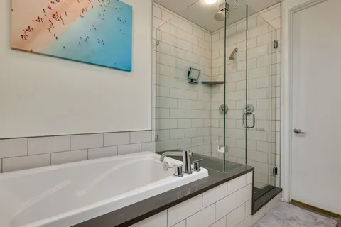 a bathroom with a bathtub and shower