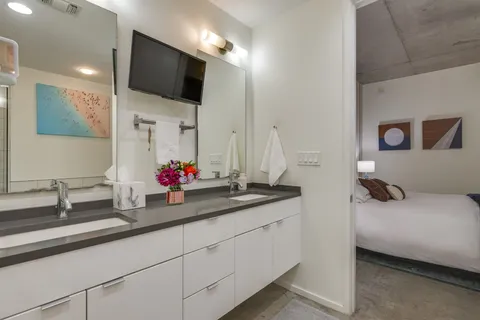 a en suite bathroom with double sink and a mirror