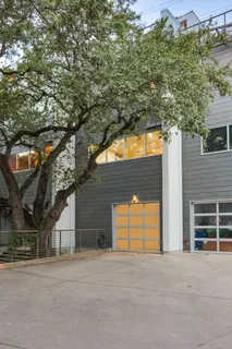 front view of a house with a yard and an trees