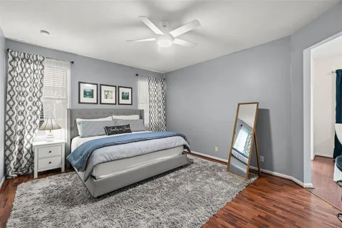 a bedroom with a large bed and a chandelier