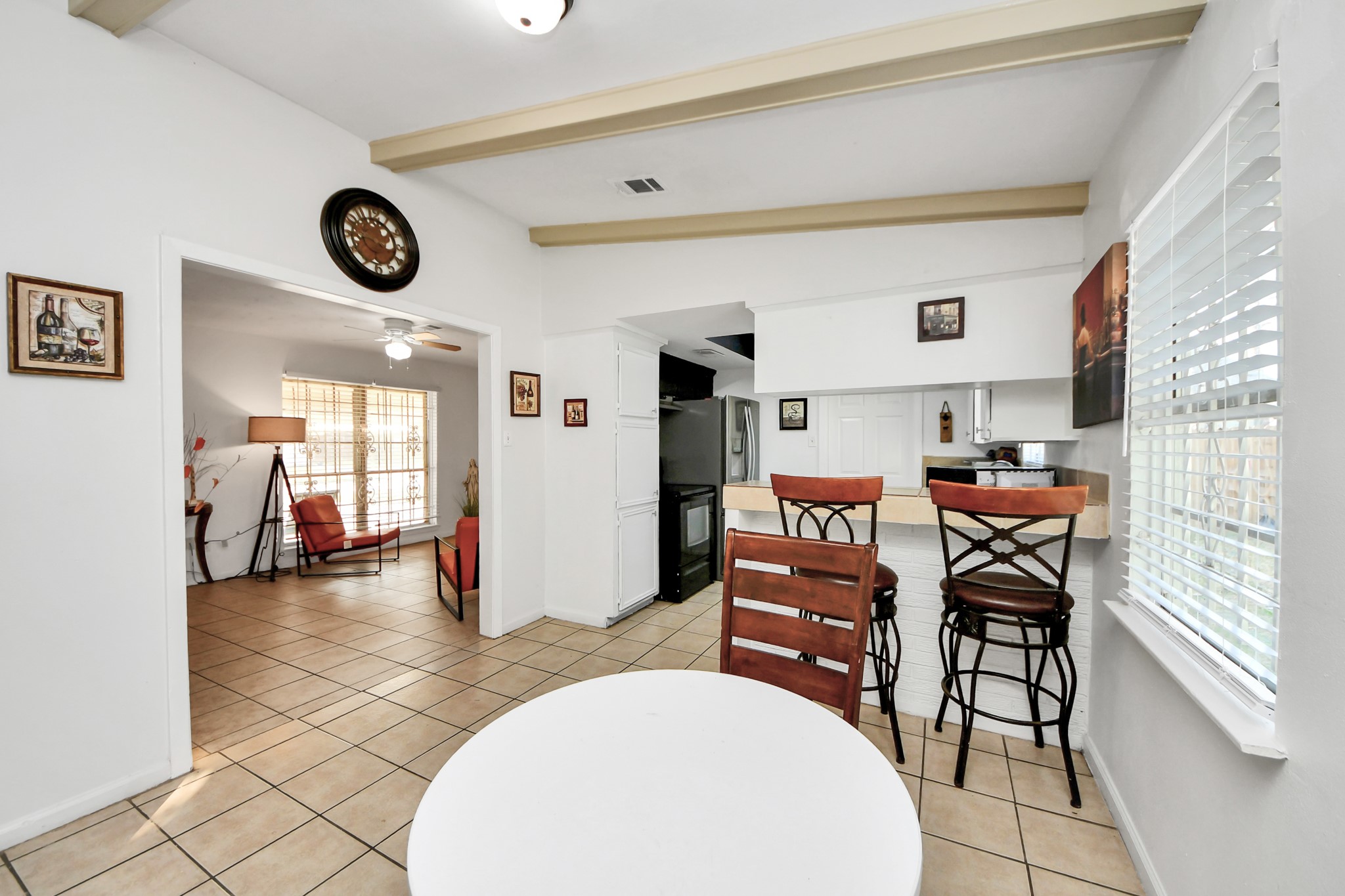 6319 Guadalupe Street Houston, TX 77016 - Photo 13 of 32 a view of a room that has a table and a clock on the wall