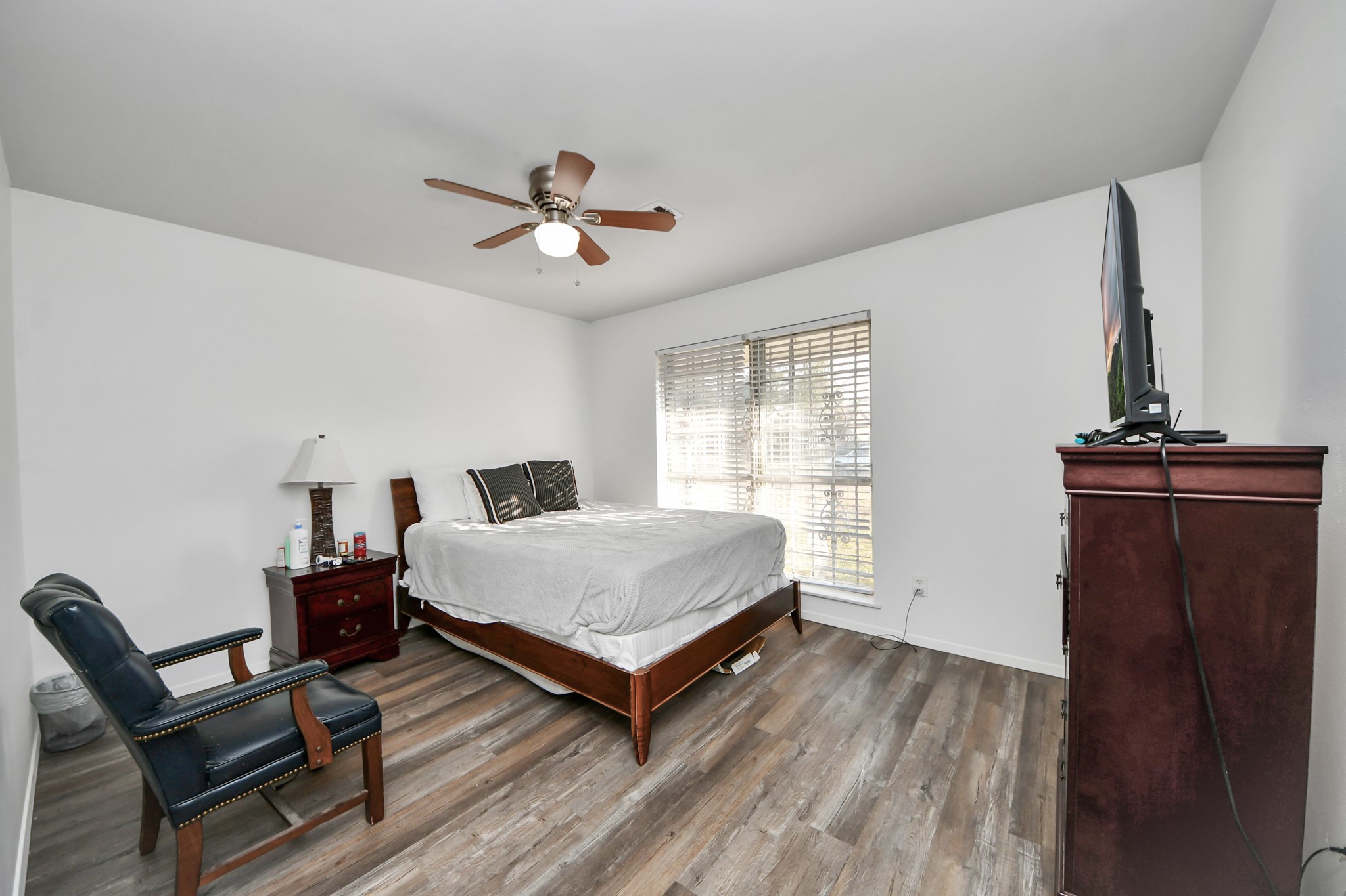 6319 Guadalupe Street Houston, TX 77016 - Photo 16 of 32 a bedroom with a bed and wooden floor