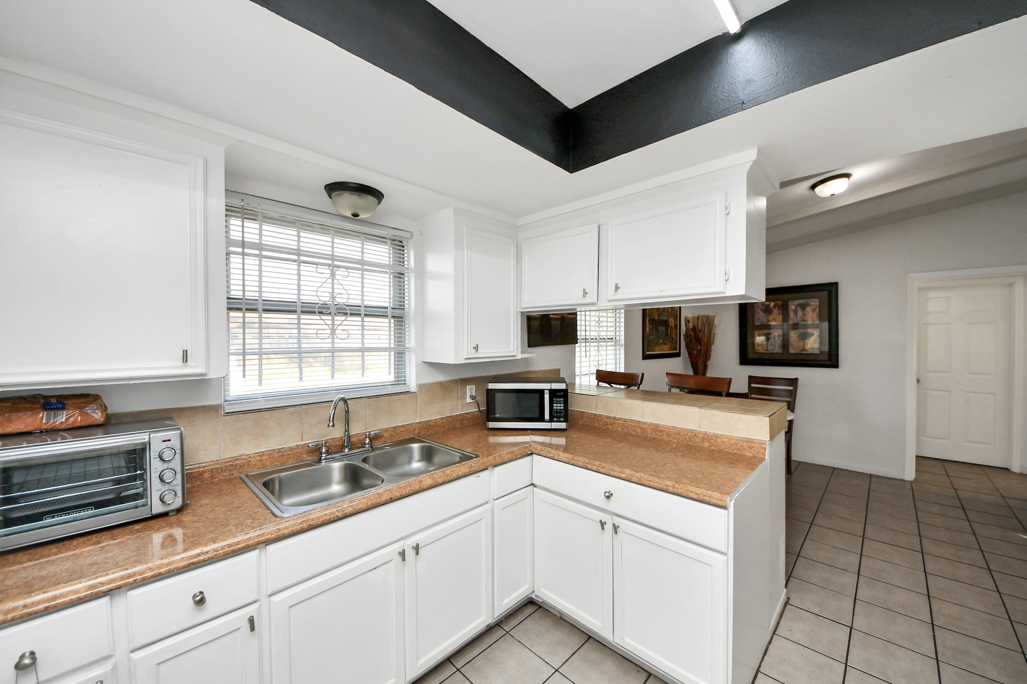 6319 Guadalupe Street Houston, TX 77016 - Photo 23 of 32 a kitchen with stainless steel appliances granite countertop a sink a stove and cabinets
