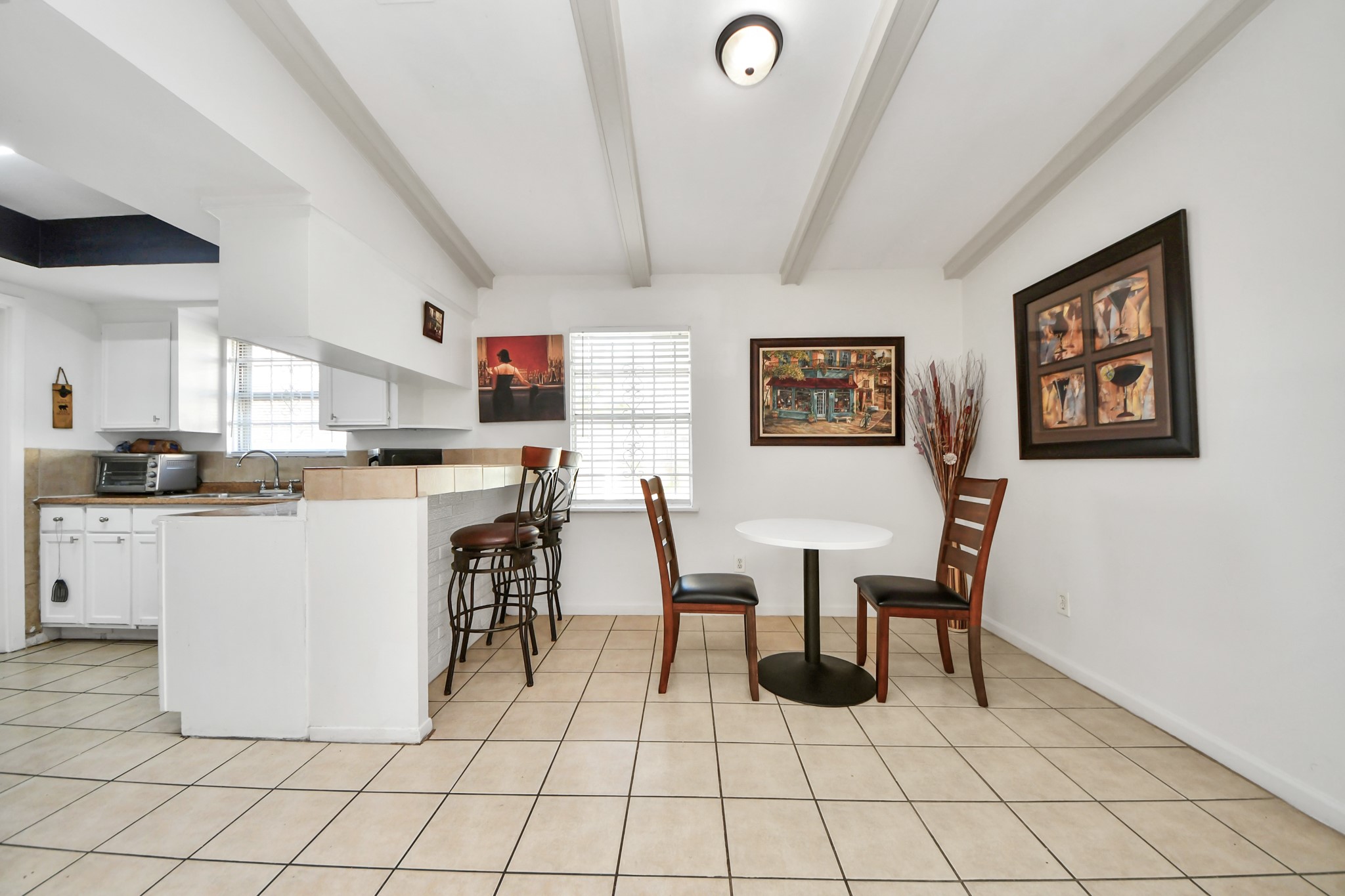6319 Guadalupe Street Houston, TX 77016 - Photo 24 of 32 a kitchen with stainless steel appliances kitchen island granite countertop a refrigerator a stove a sink with a dining table and chairs