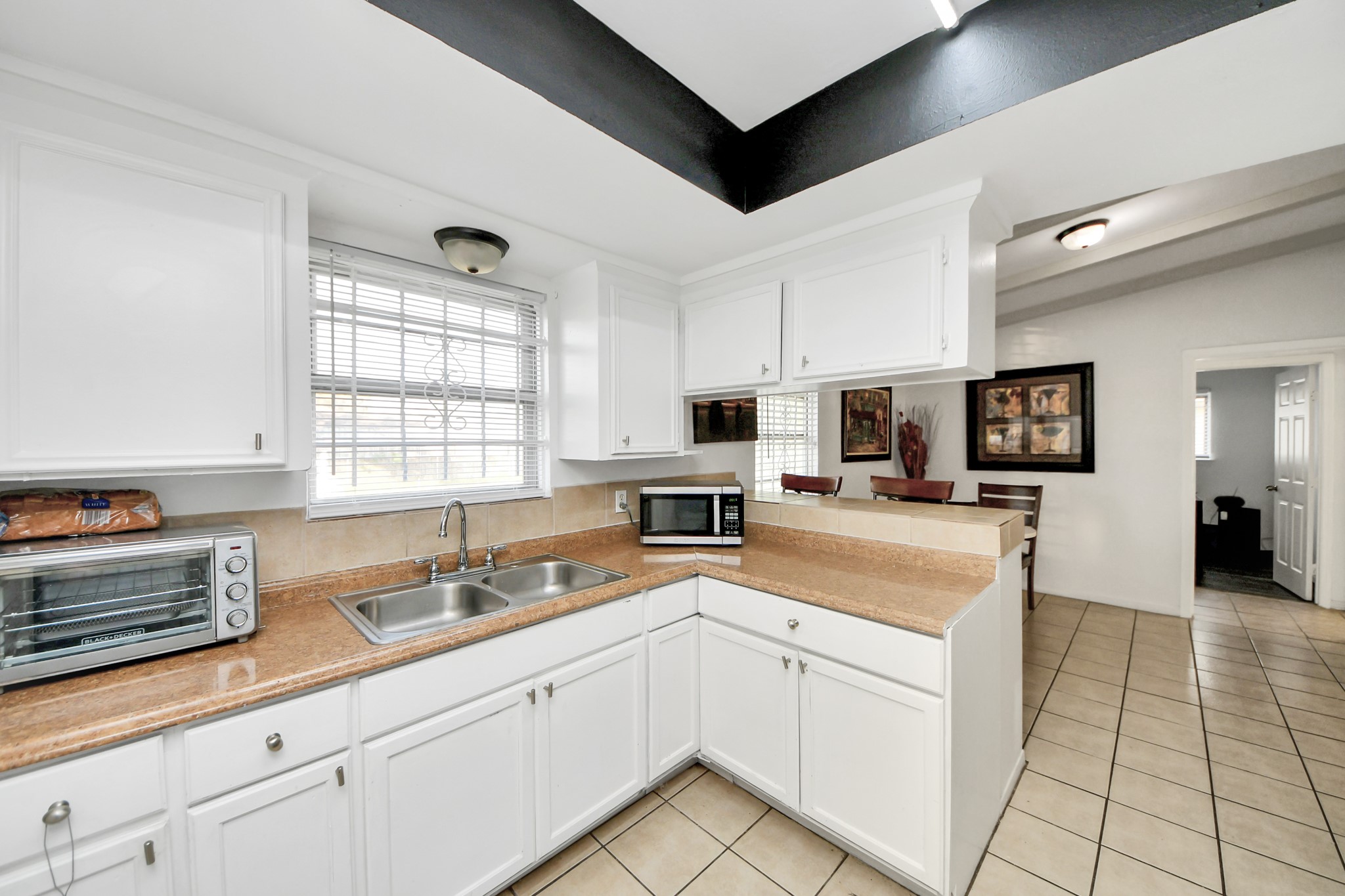6319 Guadalupe Street Houston, TX 77016 - Photo 5 of 32 a kitchen with lot of cabinets and window