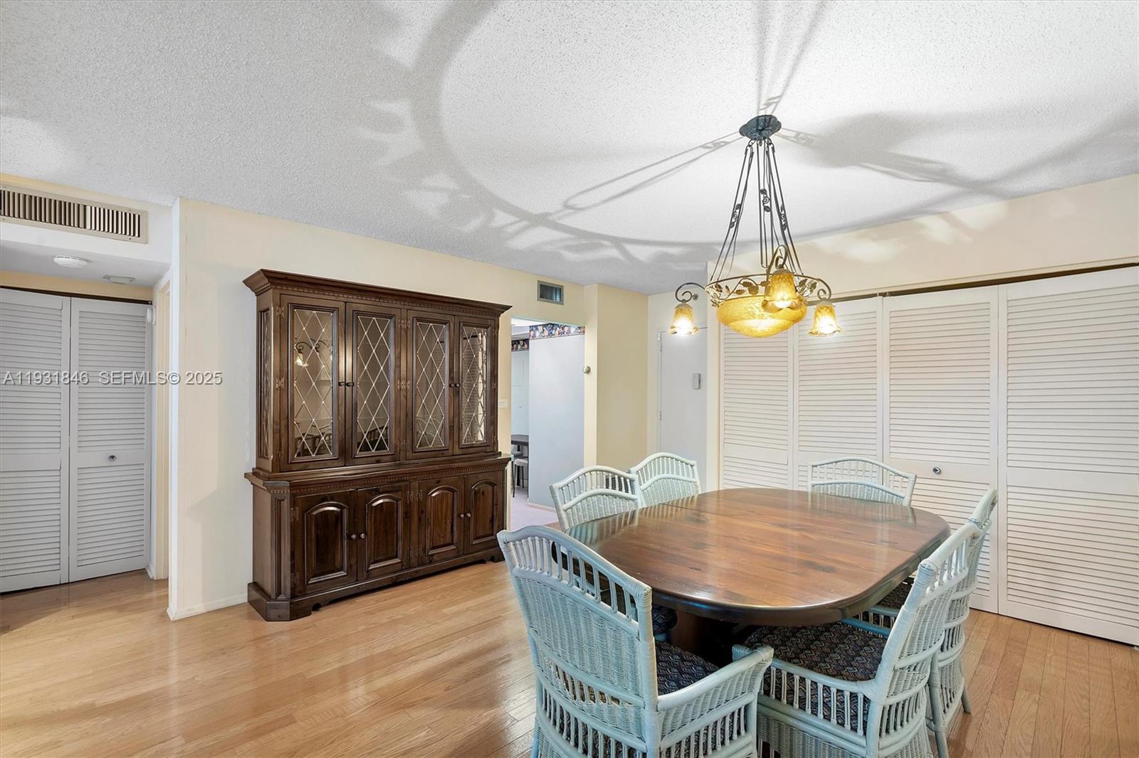 9511 Collins Avenue, Unit 606 Surfside, FL 33154 - Photo 11 of 43 a view of a dining room with furniture and wooden floor