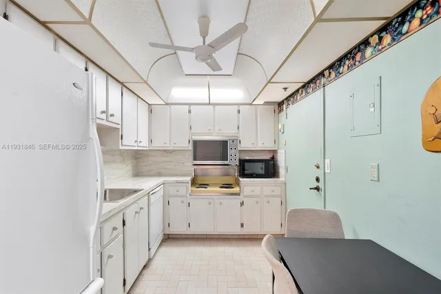a kitchen with cabinets a sink and a stove