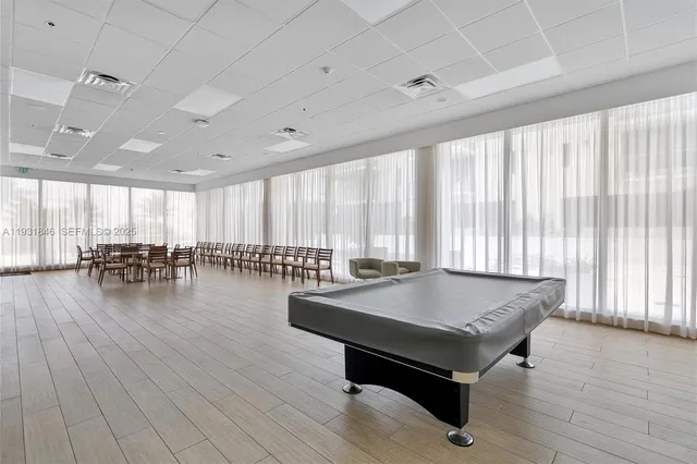 a dining room with furniture and wooden floor
