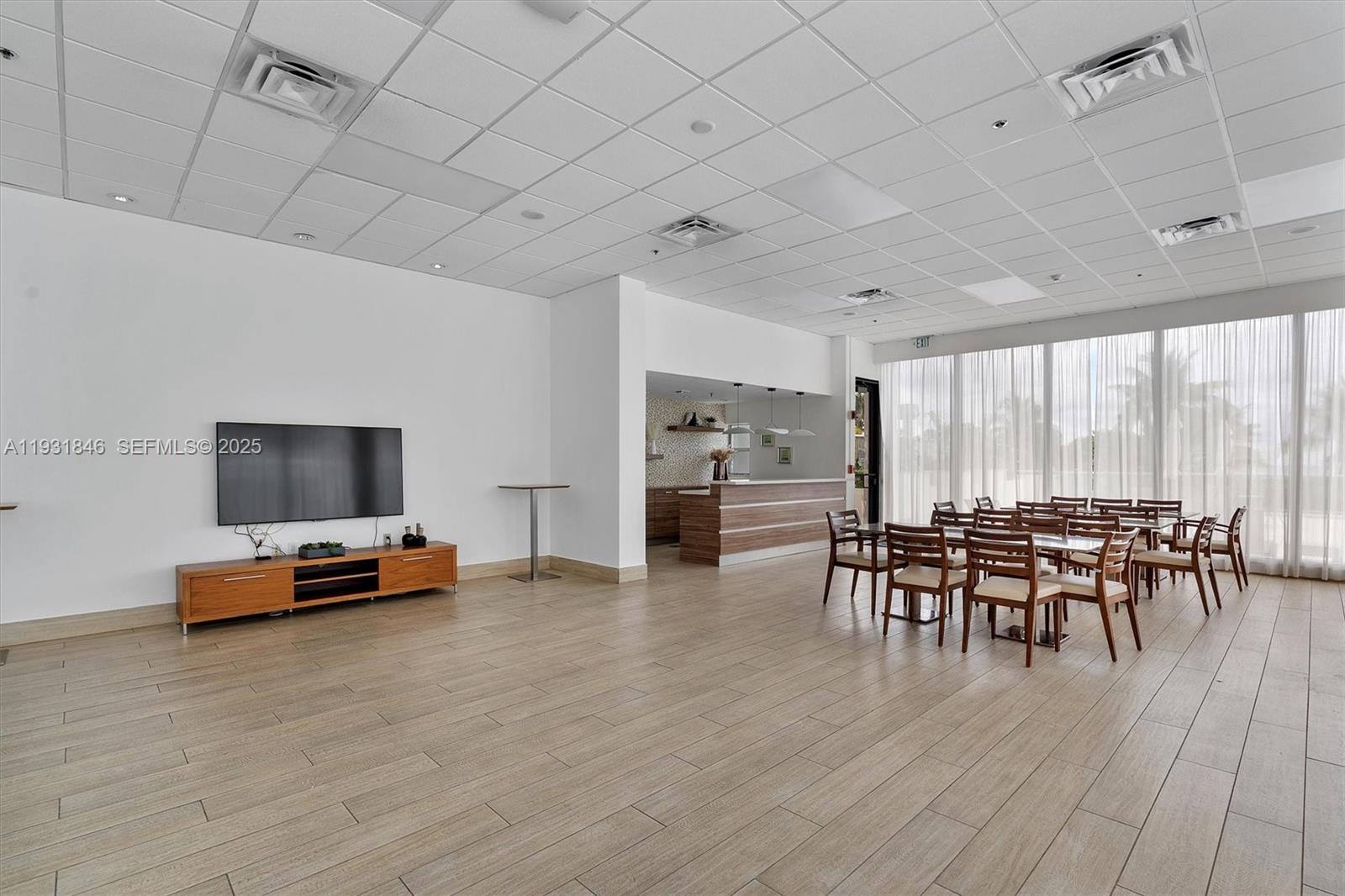 9511 Collins Avenue, Unit 606 Surfside, FL 33154 - Photo 34 of 43 a dining room with furniture and wooden floor