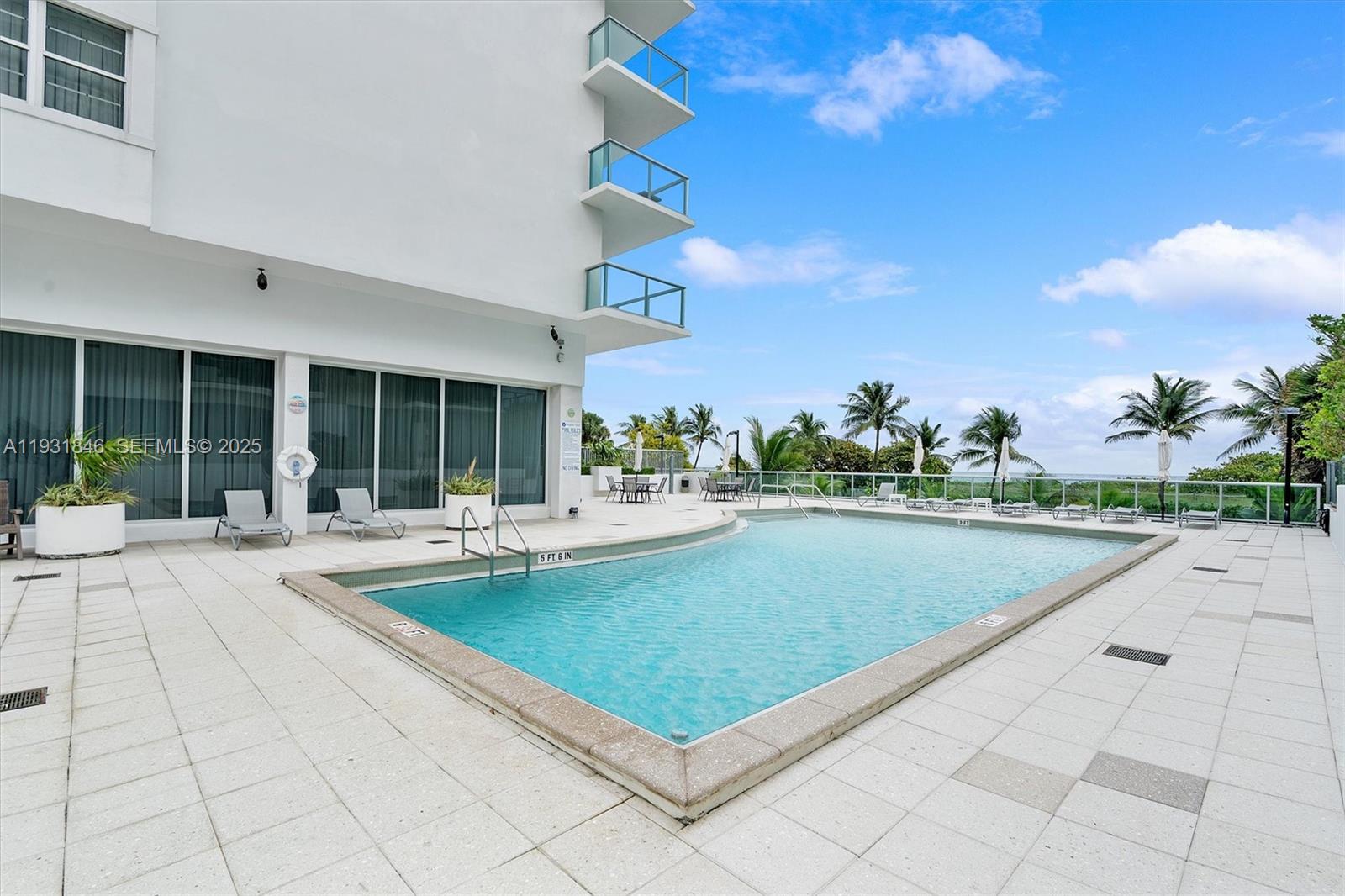 9511 Collins Avenue, Unit 606 Surfside, FL 33154 - Photo 36 of 43 a view of swimming pool with outdoor seating and a garden
