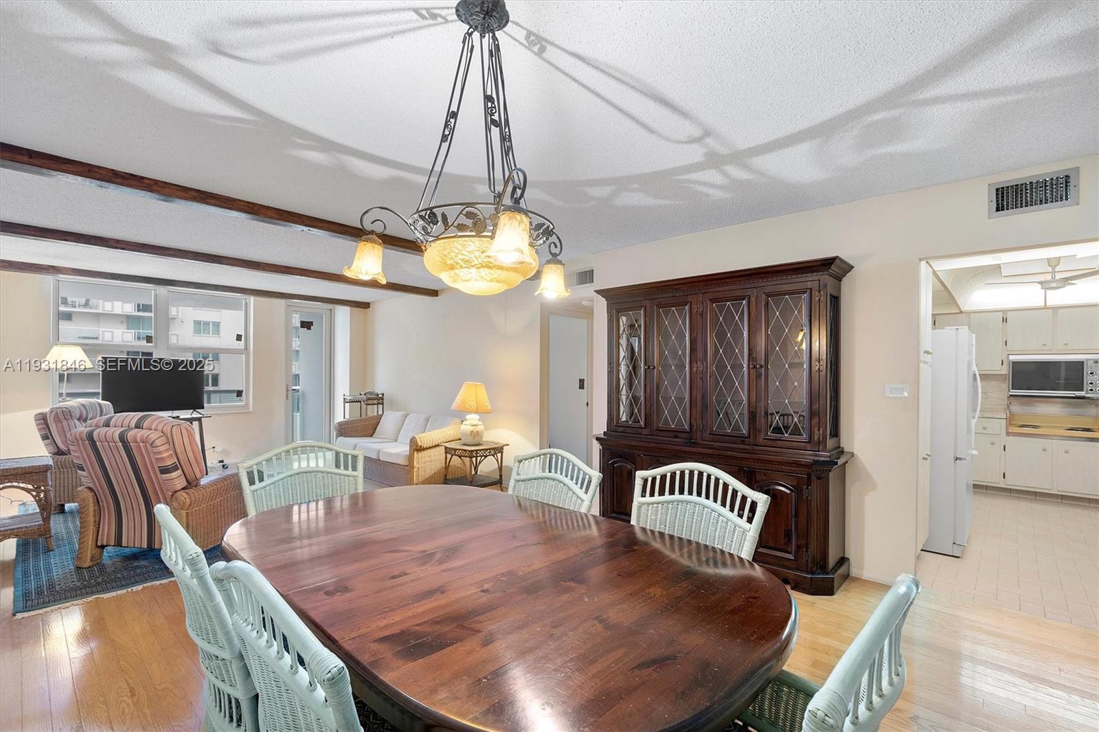 9511 Collins Avenue, Unit 606 Surfside, FL 33154 - Photo 5 of 43 a view of a dining room with furniture