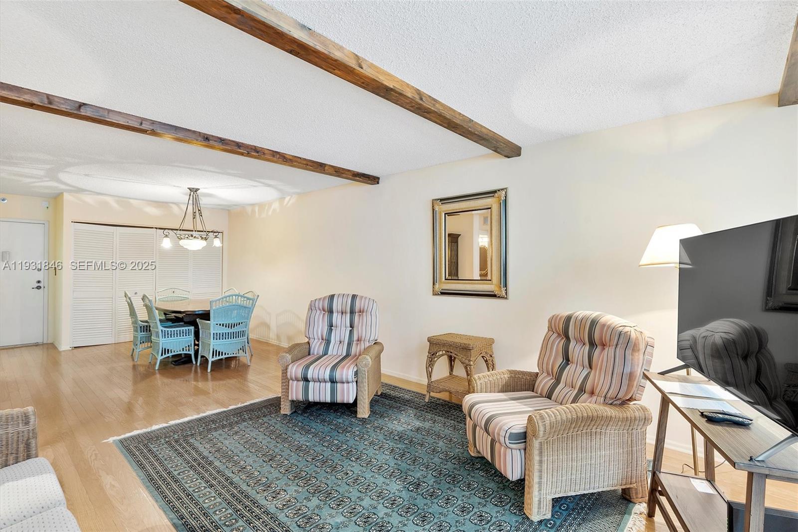 9511 Collins Avenue, Unit 606 Surfside, FL 33154 - Photo 8 of 43 a living room with furniture and a wooden floor