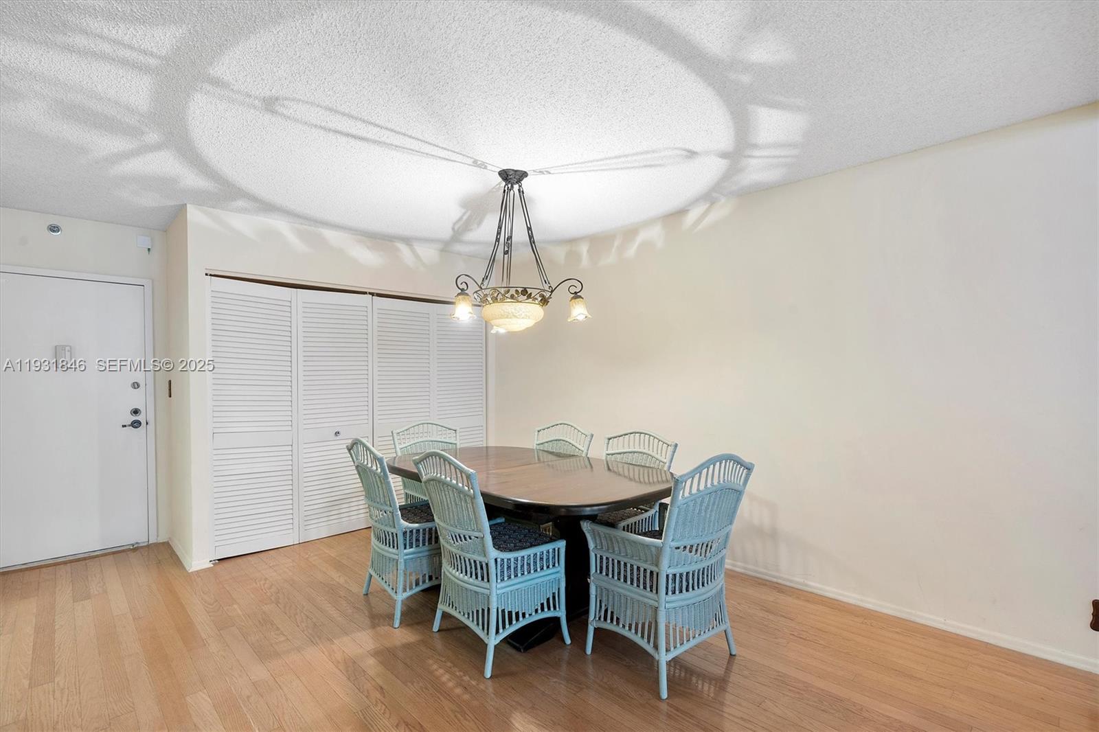 9511 Collins Avenue, Unit 606 Surfside, FL 33154 - Photo 10 of 43 a dining room with furniture and wooden floor