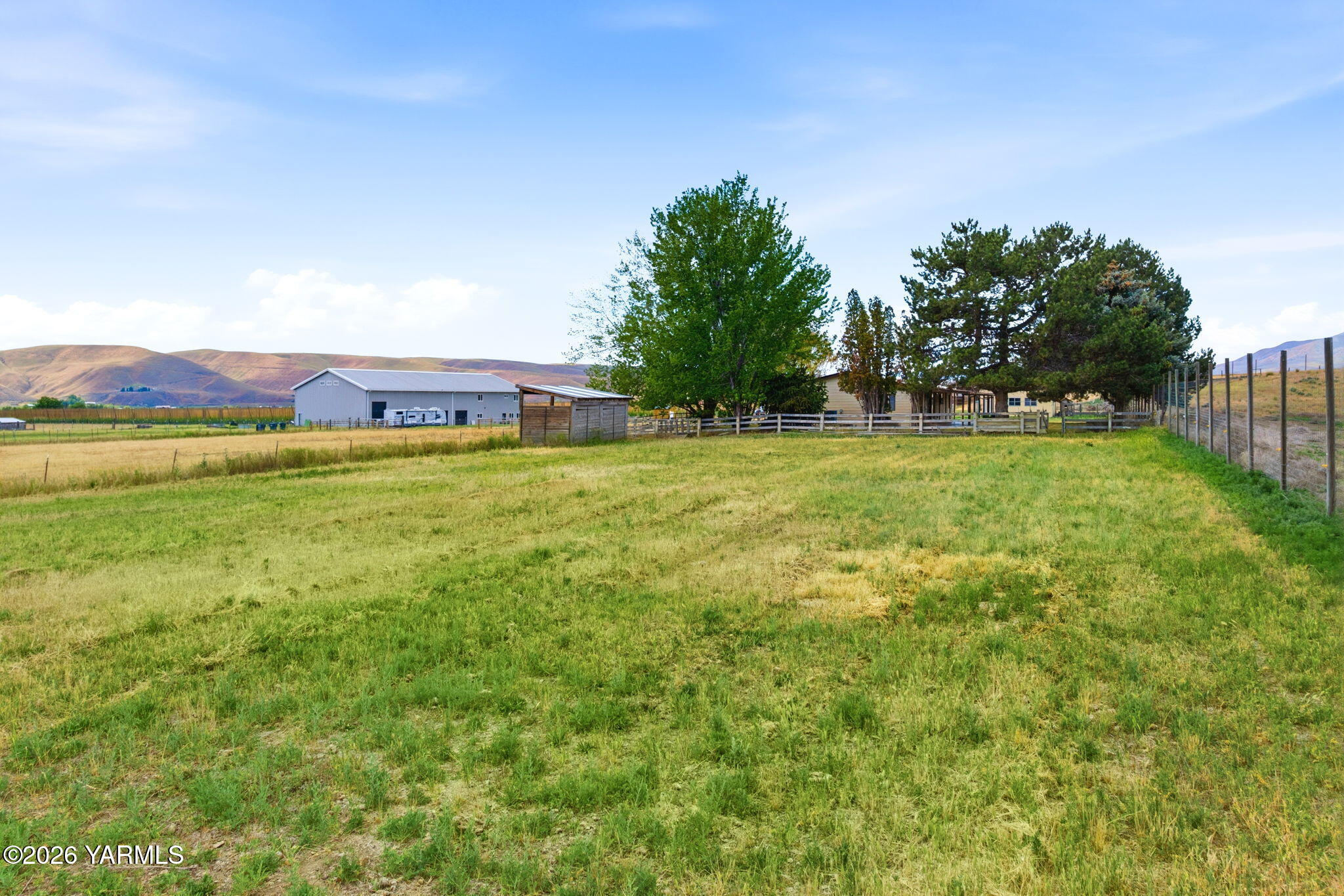 171 Gopher Road Selah, WA 98942 - Photo 22 of 24 a view of a big yard with swimming pool and large trees