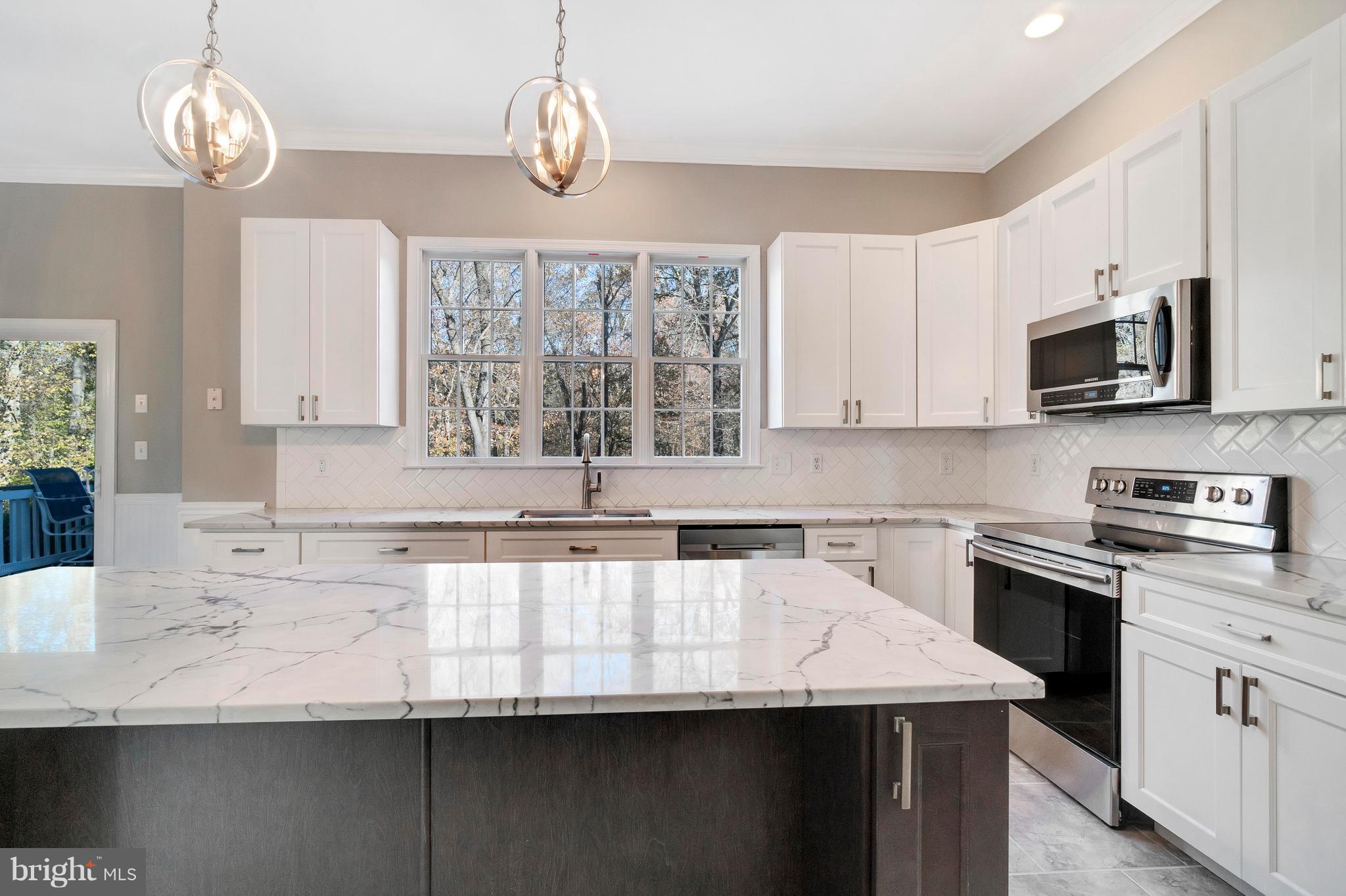 2220 Monkton Road Monkton, MD 21111 - Photo 14 of 45 a kitchen with stainless steel appliances granite countertop a sink a stove top oven a counter space and cabinets