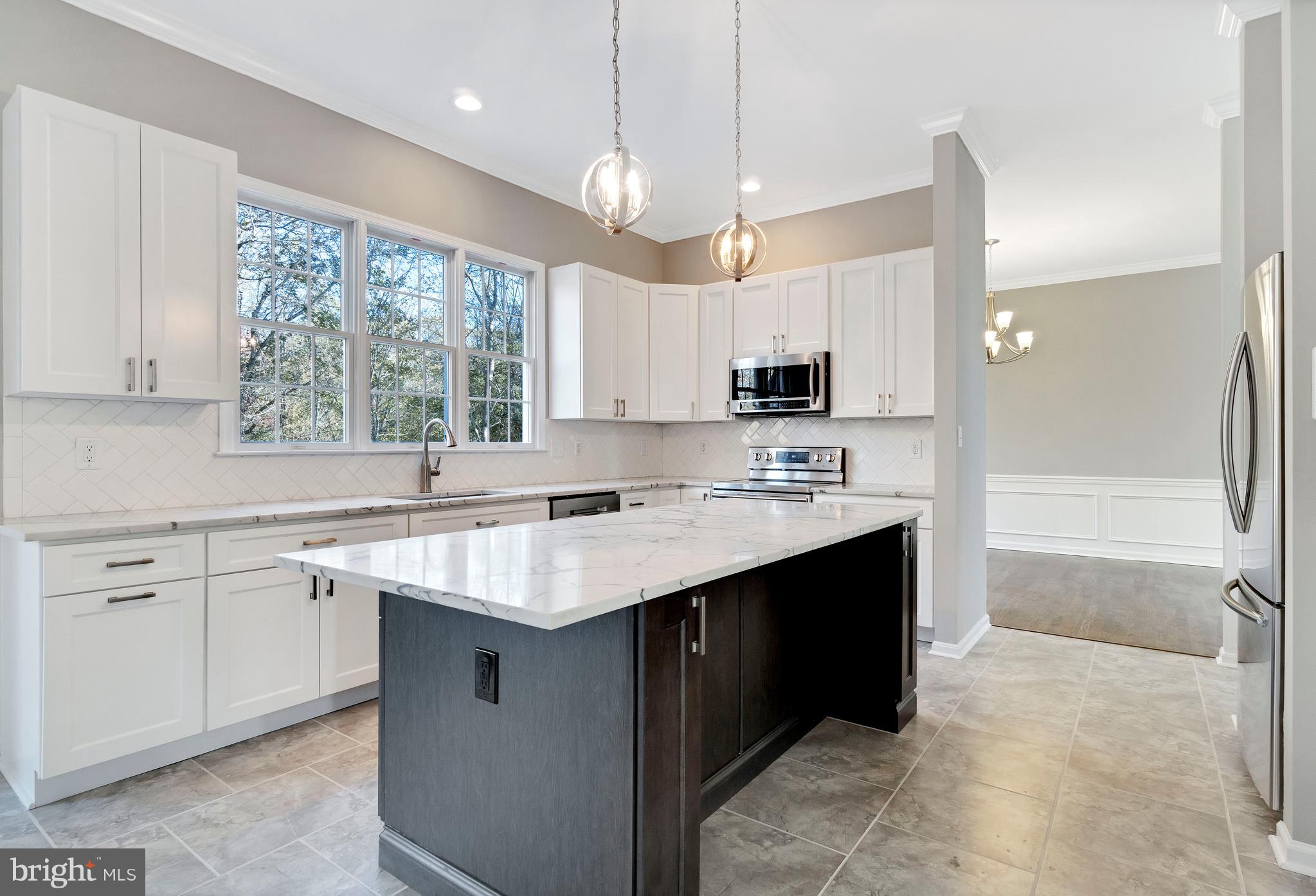 2220 Monkton Road Monkton, MD 21111 - Photo 19 of 45 a kitchen with kitchen island granite countertop a sink window and cabinets