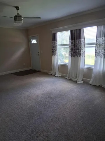 an empty room with windows and entrance