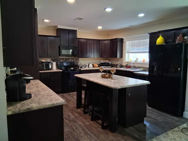 a kitchen with a sink a counter top space and appliances