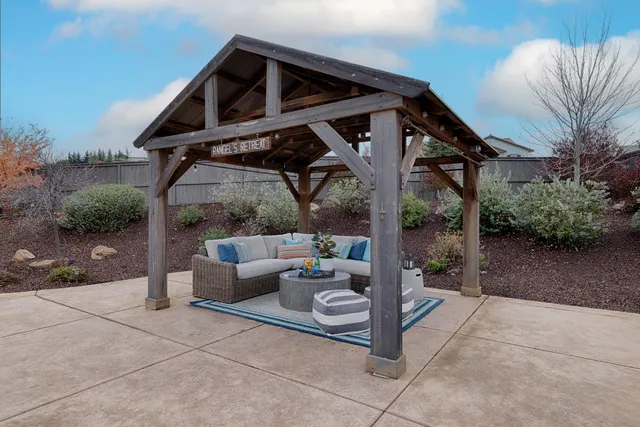 a view of a patio with couches and a table and chairs