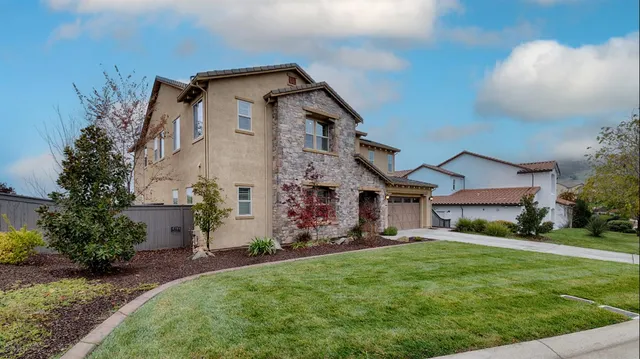 a front view of a house with a yard and garage