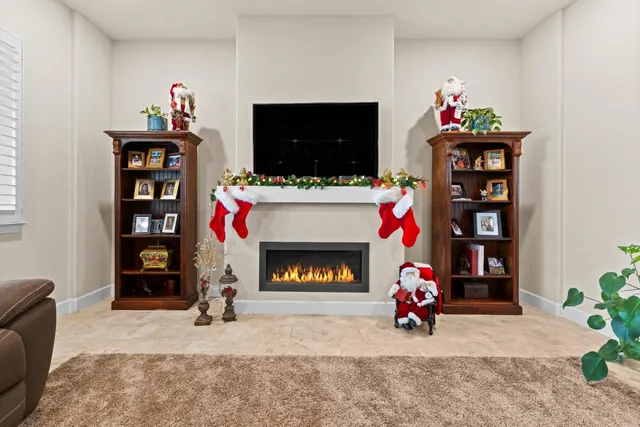 a living room with a flat screen tv and a fireplace